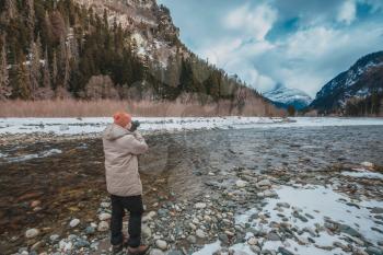 High mountains under snow in the winter. A series of photos of the Caucasus Mountains, ski resort Dombay, Karachay-Cherkessia. Man take photo of great view