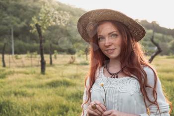 happy laughing girl holding straw walking in the green summer park