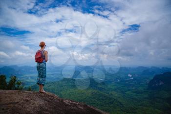 Happy hiker with her arms outstretched, freedom and happiness, achievement in mountains. Thailand, View Point, Nature Trail, Tab Kak