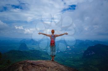 Happy hiker with her arms outstretched, freedom and happiness, achievement in mountains. Thailand, View Point, Nature Trail, Tab Kak Hang Nak Hill