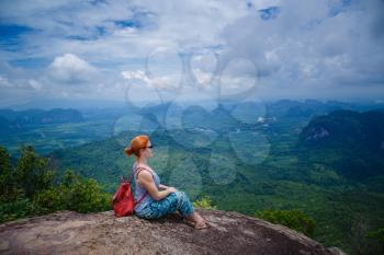 Happy hiker with her arms outstretched, freedom and happiness, achievement in mountains. Thailand, View Point, Nature Trail, Tab Kak