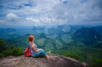 Happy hiker with her arms outstretched, freedom and happiness, achievement in mountains. Thailand, View Point, Nature Trail, Tab Kak