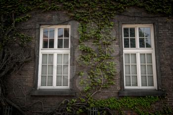 Beautiful old window on a brick wall background of an old house. Krakow, Poland