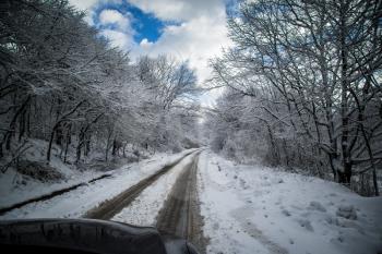 Winter Driving - Winter Road Country road leading through a winter mountain landscape.