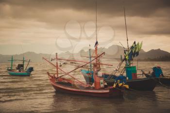 Coastal fishing boats at low tide in summer of Thailand