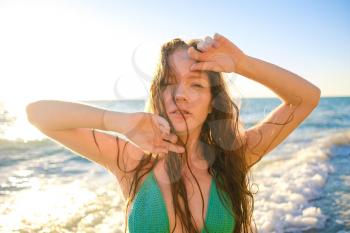 young slim beautiful woman on sunset beach, playful, dancing, running, bohemian outfit, indie style, summer vacation, sunny, having fun, positive mood, romantic, splashing water, silhouette, happy, photo toned