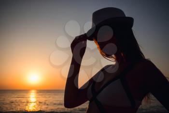 Silhouette traveler woman relaxing near the beach before sunset time summer and vacation concept