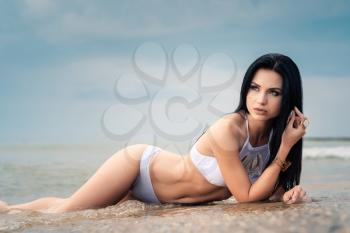 The beautiful girl in bikini on a beach. tropic island girl on vacation.