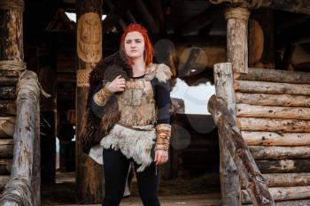 Viking woman in a traditional warrior clothes.