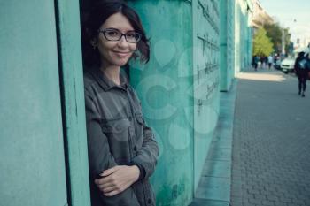 Female young traveler in the old town in Warsaw, Poland. The building and park of the Library in Warsaw