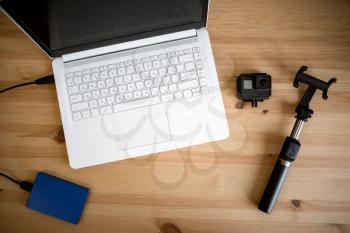Work space on table of photographer. Minimal workspace with Laptop, camera and lens copy space on wooden background. Modern and elegant. Top view. Flat lay style. Close up