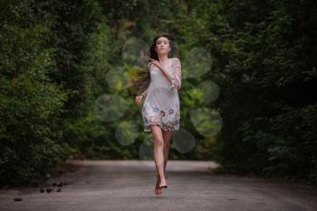 women is hailing a car on a road. Thumbing a ride. Outdoors vacation. Asian