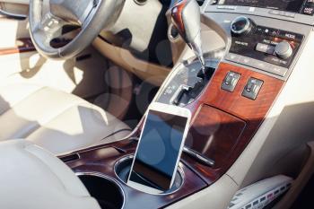 smart phone phone on the car seat dashboard. Lifestyles photo in car. Different views. Without hand, phone.