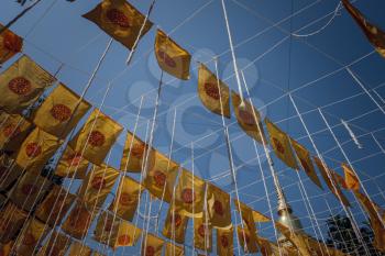 The central and ancient part of the city of Chiang Mai, Thailand. yellow flags in the blue sky, Ancient temples