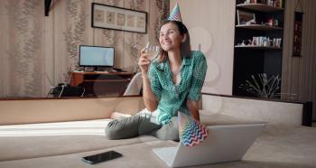 Girl celebrating birthday online in quarantine time through video call virtual party. Coronavirus outbreak 2020.