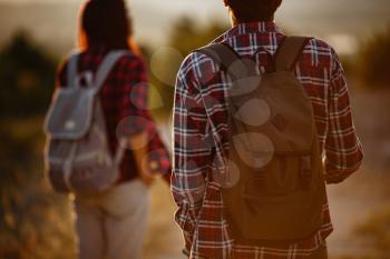 Portrait of happy young couple having fun on their hiking trip. Caucasian and asian hiker couple enjoying themselves on summer vacation. Young people hiking in nature.