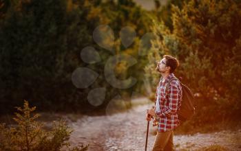 Young Man Traveler with backpack relaxing outdoor with rocky mountains on background. Lifestyle, and hobby concept