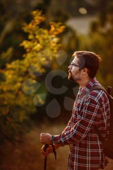 Young Man Traveler with backpack relaxing outdoor with rocky mountains on background. Lifestyle, and hobby concept