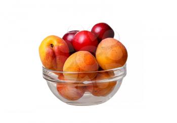 glass bowl with apricots and plums on a white background