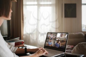 Smiling young asian woman video calling on laptop. Back view photo student looking at computer screen watching webinar or doing video chat by webcam. Over shoulder close up mock up screen view.