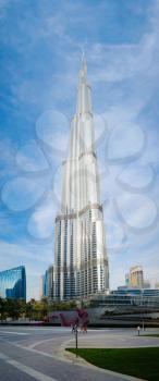 DUBAI, UNITED ARAB EMIRATES - FEBRUARY 10, 2021: Bottom-up view of Burj Khalifa in contrast with the blue sky and clouds. Burj khalifa, the highest building in the world, Downtown