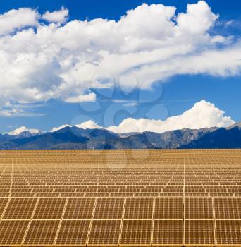 Composite of solar panel power station with mountains and bright blue sky to illustrate power generation from the sun in remote locations