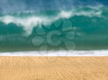 Smooth and sandy beach leading into the distance with waves