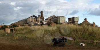 Panoramic view of old deserted sugar mill being overgrown by nature near Koloa, Kauai in Hawaii