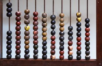 Vertical view of abacus with painted wooden beads arranged to count out calculations