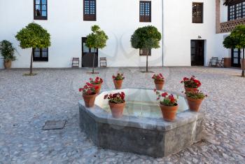 Fountain in old well in courtyard of a boutique hotel near Granada in Andalucia, Spain