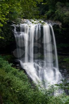 Dry Falls waterfall with blurred motion cascading down the rocks on Mountain Water Scenic Byway near Highlands in North Carolina, USA