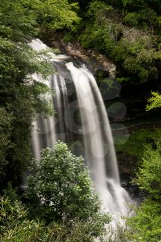 Dry Falls waterfall with blurred motion cascading down the rocks on Mountain Water Scenic Byway near Highlands in North Carolina, USA