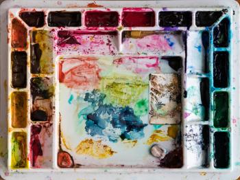 Multi colored water color painting palette mixing tray used to create shades of colour