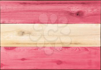 Timber planks of wood that have been painted or stained in the colors of an Austrian or Austria flag as a background