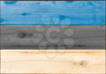 Timber planks of wood that have been painted or stained in the colors of an Estonian flag as a background