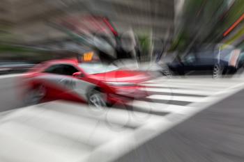 Abstract treatment of red taxi in busy traffic on daily commute to work in Washington DC as it crosses an intersection