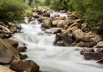 Water cascading between granite rocks in simple blurred motion images of waterfall