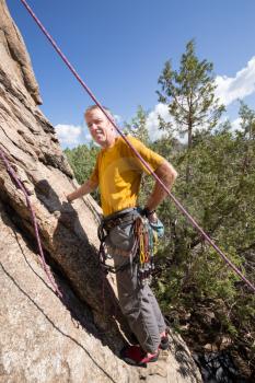 Senior male climber well equipped with cams and caribiners on Turtle Rocks near Buena Vista Colorado