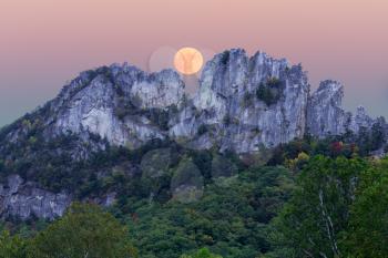 Composite of the supermoon over the rocky mountain top of Seneca Rocks in West Virginia