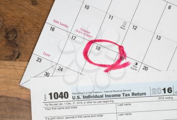 Calendar on top of form 1040 income tax form for 2016 showing tax day for filing is April 18 2017