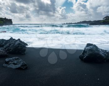 Black sand beach at Waianapanapa State Park on the road to Hana in Maui, Hawaii