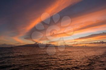 Dramatic sunset behind Lanai off Hawaiian island of Maui. Taken on Front St in resort town of Lahaina