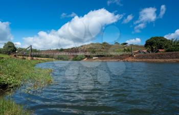 Wide angle view of the famous wooden suspension swinging bridge to cross the river in Hanapepe Kauai