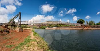 Wide angle view of the famous wooden suspension swinging bridge to cross the river in Hanapepe Kauai