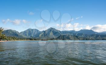 Afternoon from boat trip at Hanalei Bay and pier with the Na Pali coast in the background near Hanalei, Kauai, Hawaii