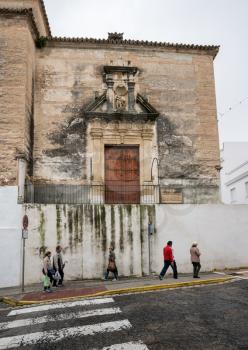 Locals walking past Church of San Miguel in Arcos de la Frontera near Cadiz in Spain