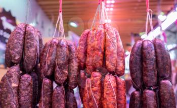 Newly made sausages hanging from string in Valencia market in Spain