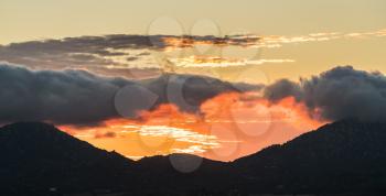 Sun setting behind mountains near to Ramona in the deserts of southern california