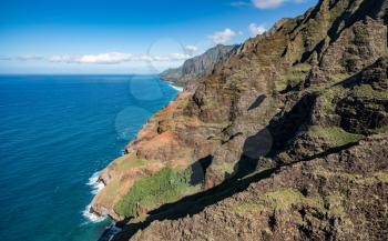 Aerial view of Na Pali coastline and landscape of hawaiian island of Kauai from helicopter flight