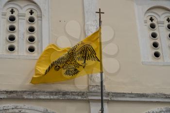 Double-headed flag on St George Orthodox church in old town in the city of Nafplio in Greece